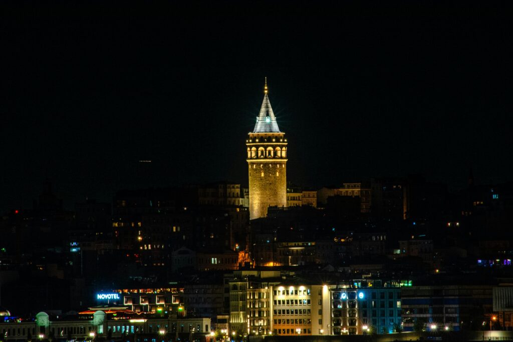 Stunning nighttime shot of the historic Galata Tower illuminated against the İstanbul skyline.